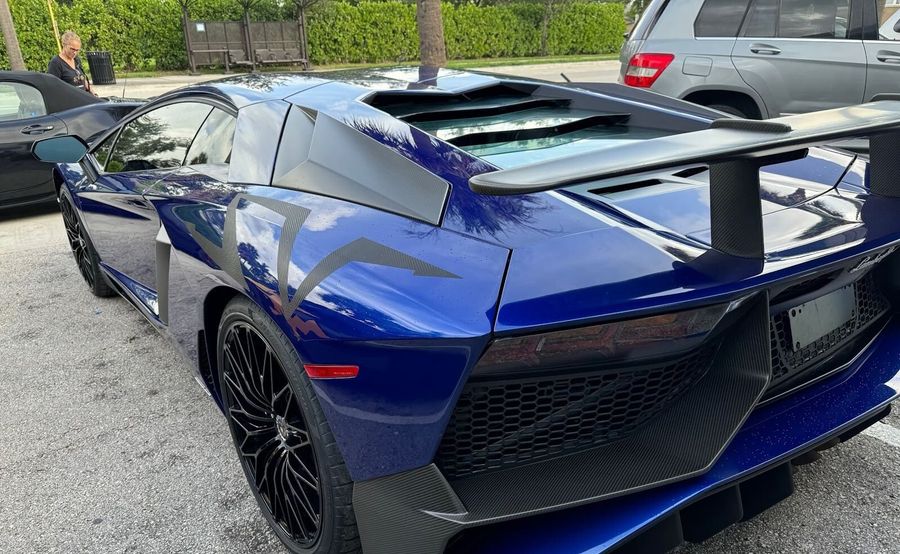Blue Lamborghini Aventador SV rear three-quarter view after collision repair at Gold Coast Collision Center, Pompano Beach
