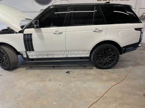 White Range Rover with the doors stripped for side panel collision repair at Gold Coast Collision Center
